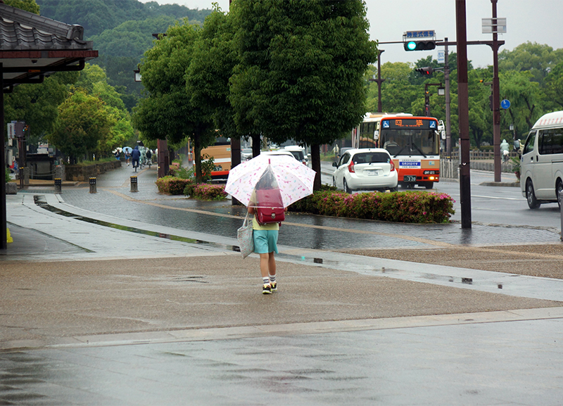 傘をさして歩く女の子